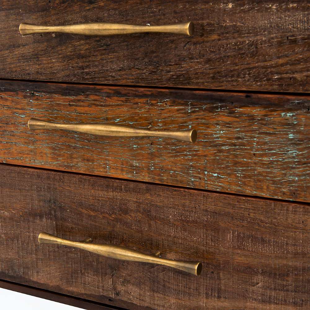 Textured wood drawer fronts with long brushed brass handles are featured on Crate & Barrel Sedgwick Solid Acacia Wood Desk with Storage