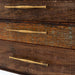 Textured wood drawer fronts with long brushed brass handles are featured on Crate & Barrel Sedgwick Solid Acacia Wood Desk with Storage