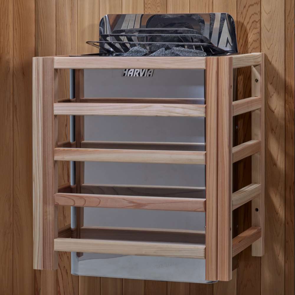 The Harvia stove for Golden Designs Arlberg 3 Person Traditional Outdoor Sauna mounted on a cedar wall inside a slatted light wood safety guard