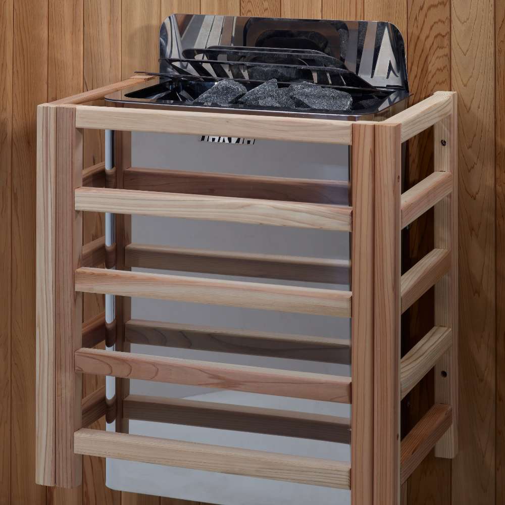 The Harvia stove for Golden Designs Copenhagen 3 Person Traditional Sauna mounted on a cedar wall inside a slatted light wood safety guard