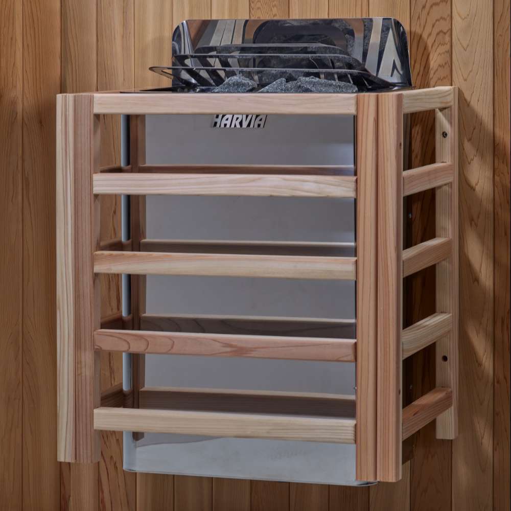 The Harvia stove for Golden Designs Gargellen 5 Person Hybrid Outdoor Sauna mounted on a cedar wall inside a slatted light wood safety guard
