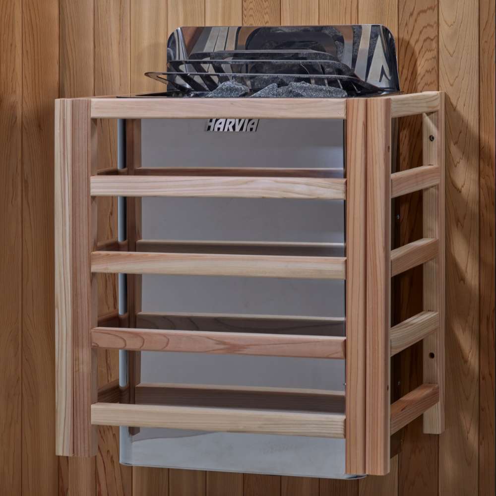 The Harvia stove for Golden Designs St. Moritz 2 Person Barrel Traditional Sauna mounted on a cedar wall inside a slatted light wood safety guard