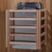 The stove for Golden Designs Hanko 2-3 Person Traditional Sauna mounted on a cedar wall inside a slatted light wood safety guard