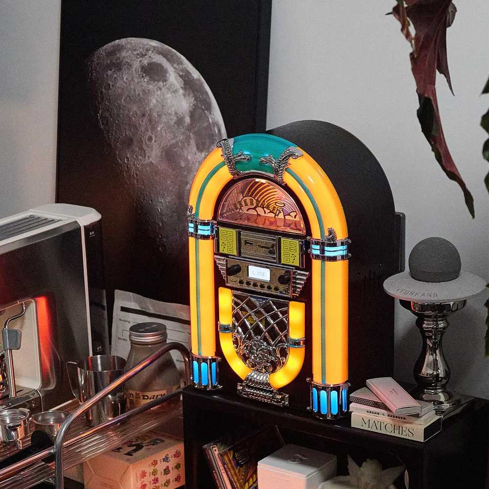 The Arkrocket Athena Mini Jukebox Tabletop CD Player Bluetooth Speaker (YellowBlack) glows brightly with yellow and turquoise LED lights