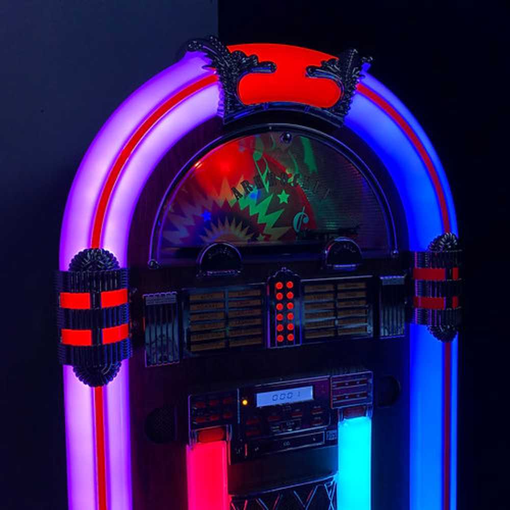 The Arkrocket Saturn V Full Size Bluetooth Vinyl Record Jukebox is illuminated with vibrant red and blue neon lights