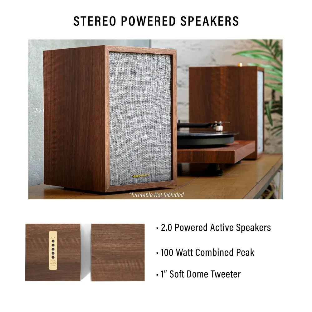 The Crosley S200 Stereo Powered Speakers - Walnut are shown in a room setup paired with a turntable, highlighting their classic aesthetic