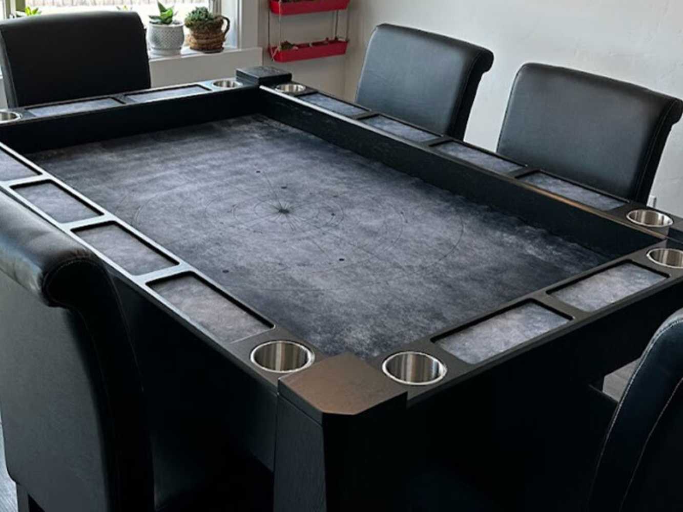 The Game Theory Tables Origins Lit Game Table has a spacious gray playing surface with integrated cup holders