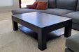 The Game Theory Tables The Origins Coffee Table in onyx color in a living room setting