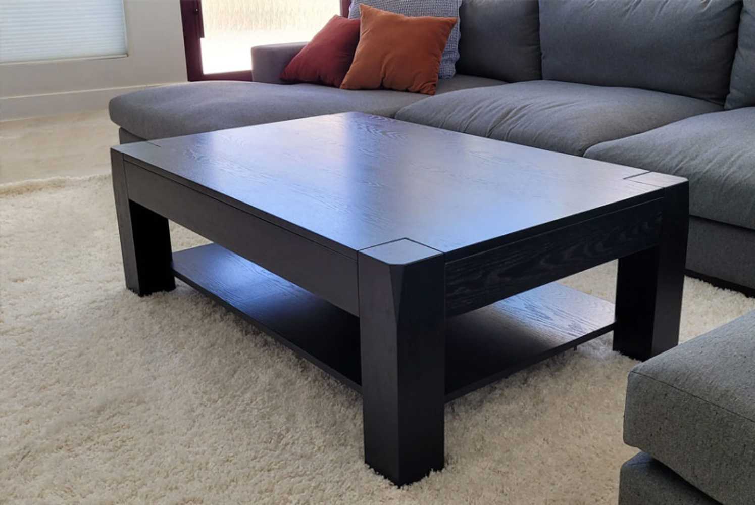 The Game Theory Tables The Origins Coffee Table in onyx color in a living room setting