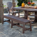 The LuxCraft Cafe Dining Bench 72 is placed next to an outdoor dining table surrounded by fall decorations