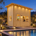 The Cube Loft 100 Freedom Office illuminated at night beside a Nevada backyard pool, with three adults enjoying sports inside and desert landscaping surrounding the structure.
