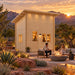 The Cube Loft 100 Freedom Office at golden hour in Nevada, featuring a compact entertainment bar, friends socializing, a modern fire feature, and red-rock landscaping.