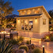 The Versa 160 Atrium 70MM Freedom Office glowing during a bright Nevada night as friends watch a sports game inside, surrounded by illuminated desert plants and distant mountains.
