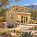 The Versa 160 Atrium 70MM Freedom Office configured as a bright home office, with two adults working inside an upscale Nevada backyard with desert landscaping and mountain views.
