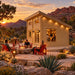 The Versa 240 70MM Freedom Office at golden hour in Nevada, transformed into a compact bar where friends gather beside a fire feature and red-rock mountains.
