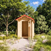 Front view of The Wee Wee House 33 with its wooden door open, revealing the compact interior beneath a red pitched roof in a landscaped garden.