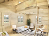 The living room of the Sawmill Structures BlueWater Loft 160 38mm Garden Room features a white sofa, tall ceilings, and a wooden ladder leading up to the loft