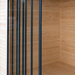 The tall, vertical glass panels of the GardenHouse24 USA ALU Concept 44Q Garden Room are neatly aligned in a wooden wall