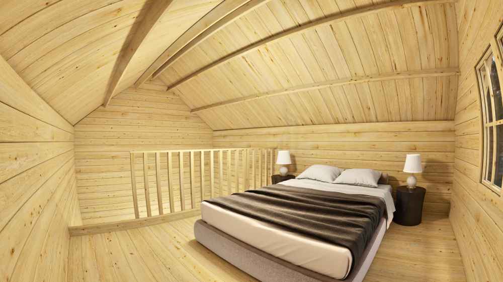 The upstairs of the Sawmill Structures GrandView 150 70MM Garden Room displays a snug bedroom with a double bed, wooden walls, and matching bedside tables