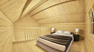 The upstairs of the Sawmill Structures GrandView 150 70MM Garden Room displays a snug bedroom with a double bed, wooden walls, and matching bedside tables