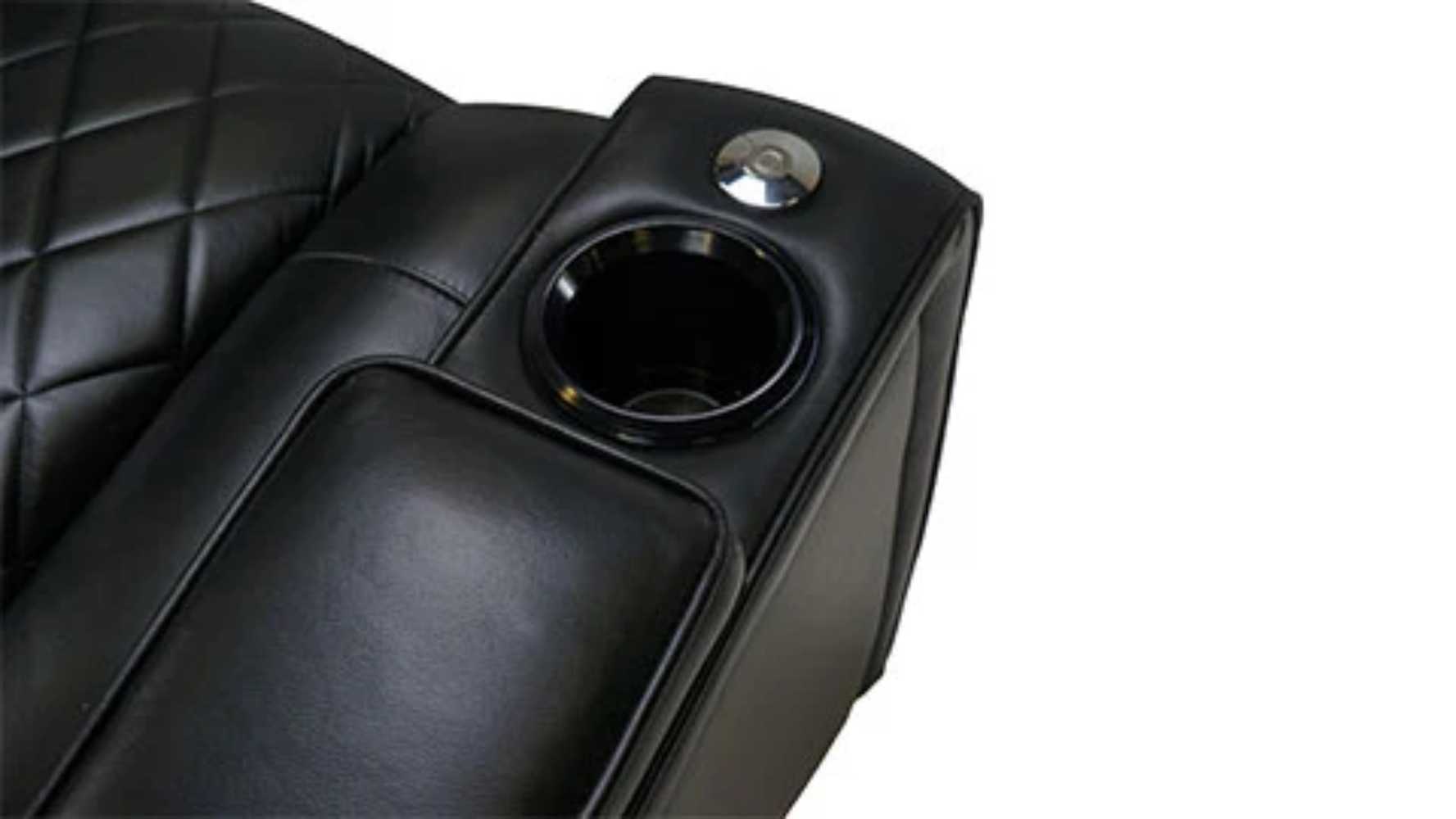 The armrest of the Valencia Oxford Console Edition Home Theater Seating includes a cupholder with LED lighting