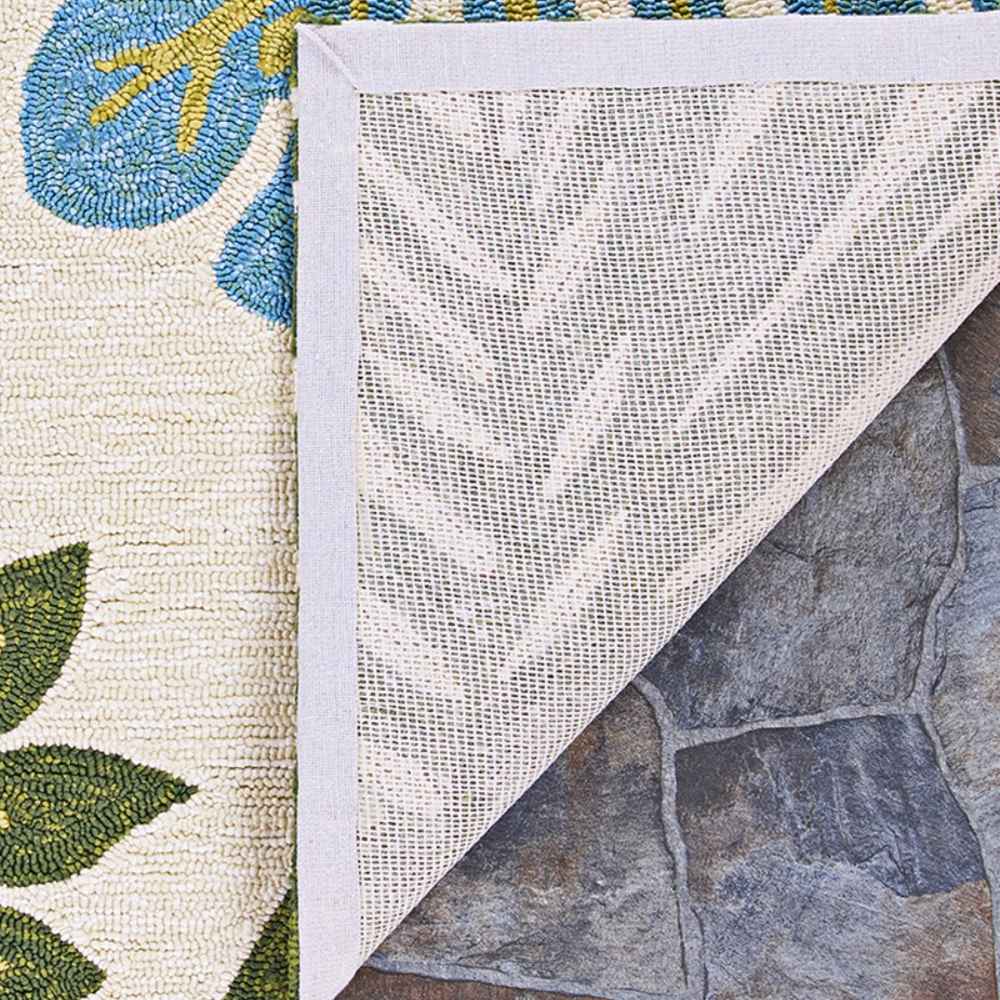 The back of the Couristan Covington Indoor/Outdoor Rug - Summer Laelia/Ivory-Fern reveals a mesh-like structure with sturdy stitched edging