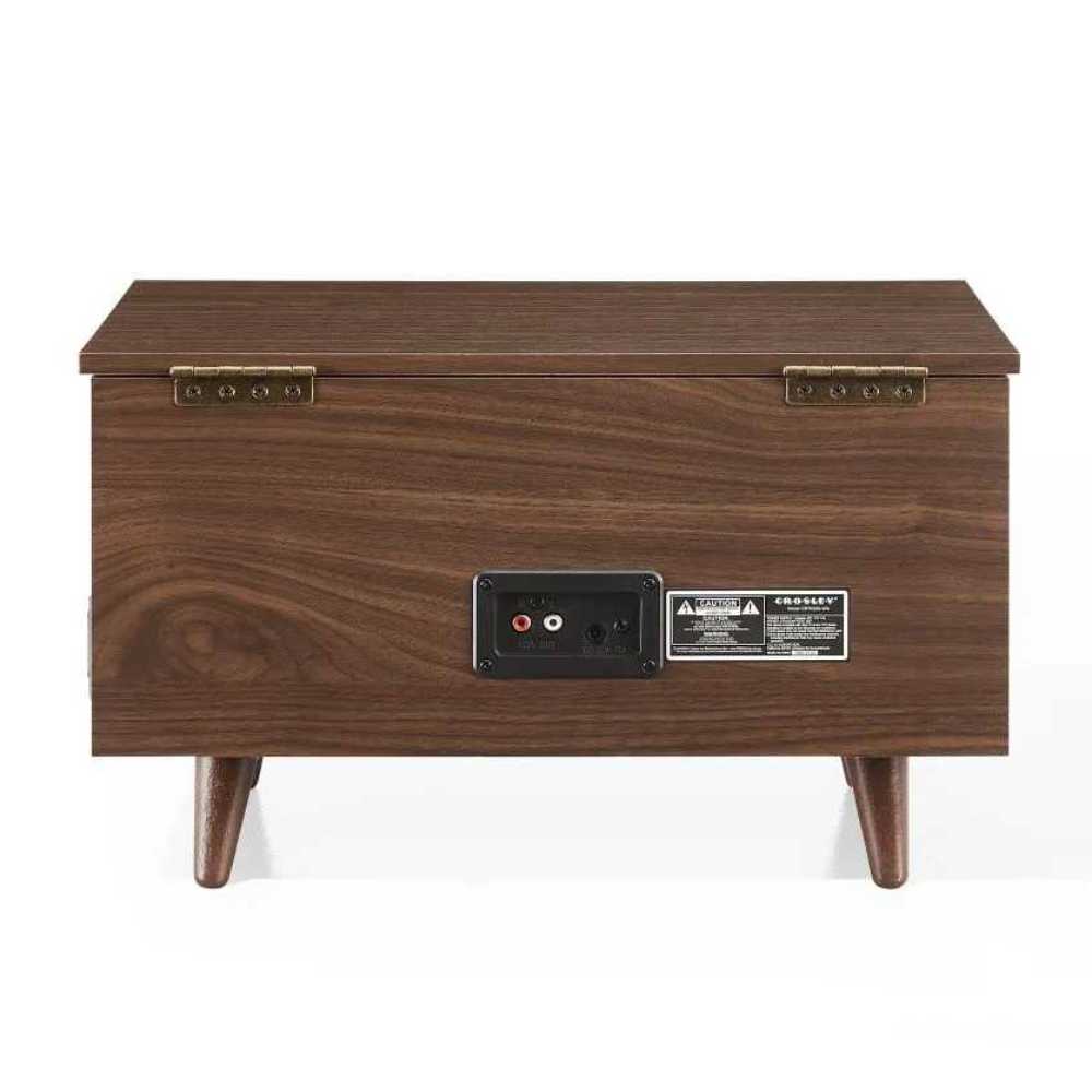 The back panel of the Crosley Serenade 8-In-1 Record Player - Walnut reveals a power input, audio output ports, and brass hinges