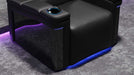 The base of the Valencia Monza Single Pillow Top Carbon Fiber Home Theater Seating illuminated with vibrant LED lighting