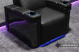 The close-up highlights the Valencia Monza Single Pillow Top Carbon Fiber Home Theater Seating's illuminated carbon fiber sides and ambient LED lighting