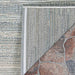 The corner of the Couristan Cape Indoor/Outdoor Rug - Shallows/Taupe-Grey is flipped to display the durable backing and fine construction