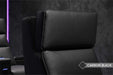 The detailed shot features the motorized headrest of the Valencia Monza Single Pillow Top Carbon Fiber Home Theater Seating