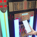 The image displays a person connecting a smartphone to Arkrocket x Elvis Presley Saturn V Full Size Jukebox with Stand highlighting its modern Bluetooth functionality