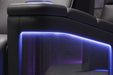 The image focuses on the carbon fiber detailing of the Valencia Monza Single Pillow Top Carbon Fiber Home Theater Seating