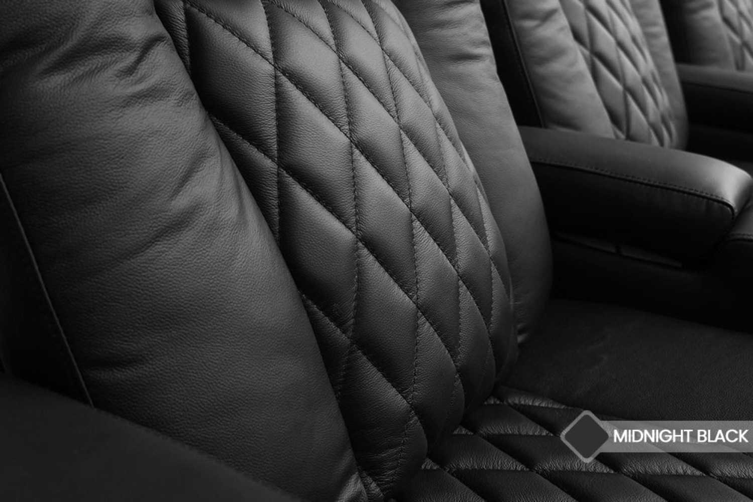 The image showcases the diamond-stitched black leather upholstery of Valencia Tuscany Home Theater Seating