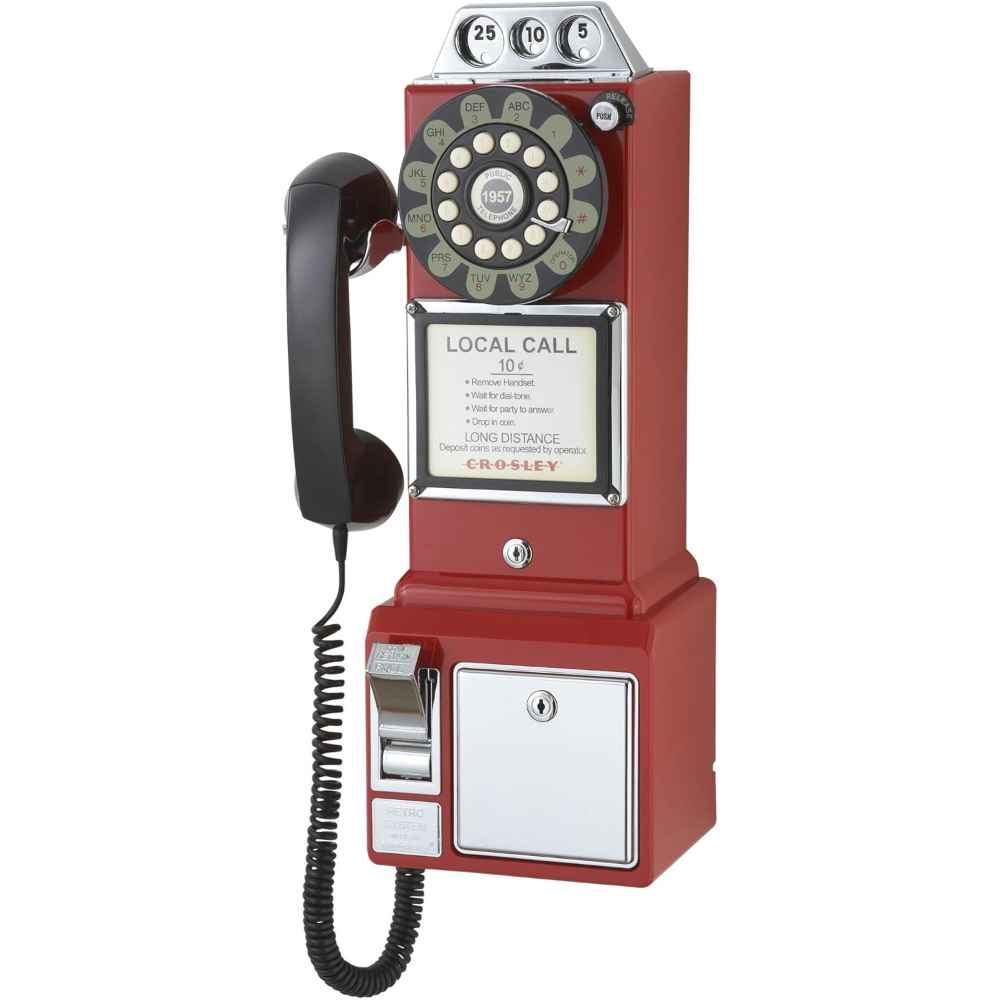 The image shows a Crosley 1950's Classic Pay Phone - Red, featuring a rotary dial, a black handset, and a coin slot design in a vibrant red finish