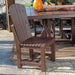 The image shows an antique mahogany LuxCraft Adirondack Side Chair placed next to a matching outdoor table with autumn decorations, on a stone patio