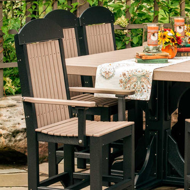 The image shows an outdoor dining setup featuring LuxCraft Classic Arm Chair with slatted back and seat panels