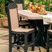 The image shows an outdoor dining setup with a cedar and black LuxCraft Classic Side Chair around a matching table decorated with fall-themed items