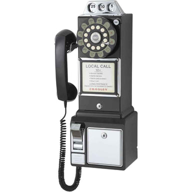 The image shows the Crosley 1950's Classic Pay Phone - Black, a retro-style wall-mounted phone with a rotary dial, coin slots, and a handset