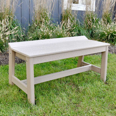 The image shows the LuxCraft Cafe Dining Bench 41 placed on a grassy lawn