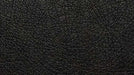 The image shows the texture of premium black leather used in Valencia Syracuse Home Theater Seating