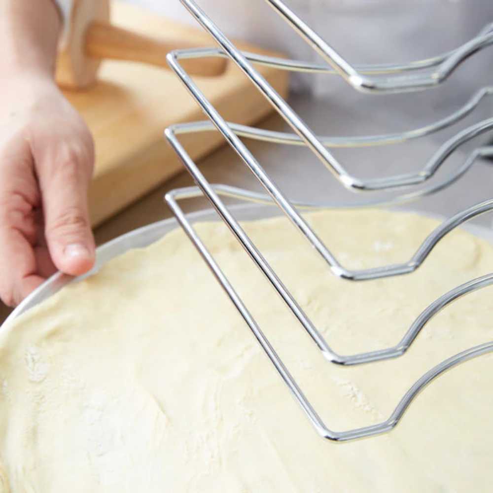 The image zooms in on a pizza pan being inserted into the Chicago Brick Oven 7 Slot Wall Mounted Pizza Pan Rack