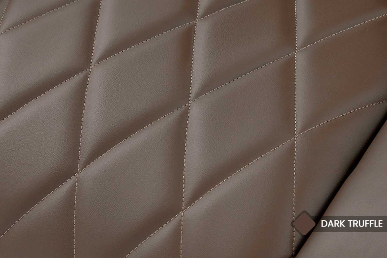 The image zooms in on the elegant quilted vegan leather texture of the dark truffle Valencia Tuscany Vegan Edition Home Theater Seating