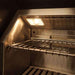 The interior of the Alfresco Grills Artisan Professional 36” Built-In Grill, 3 Burner is shown with bright halogen lighting