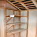 The interior of the Outdoor Living Today 9×6 Cabana Garden Shed shows wooden shelves neatly installed along one wall
