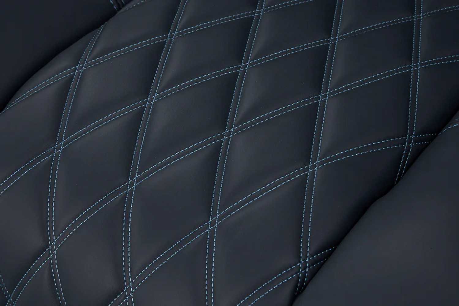 The intricate diamond-pattern stitching on the premium leather of the moonlight blue Valencia Tuscany XL Luxury Edition Home Theater Seating