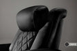 The plush and adjustable headrest in onyx, part of the Valencia Tuscany Ultimate Edition Home Theater Seating