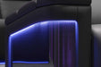 The side panel of the Valencia Monza Pillow Top Carbon Fiber Home Theater Seating showcases carbon fiber detailing illuminated by soft LED lighting