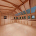 The spacious wooden interior of the Outdoor Living Today 12×16 Sunshed Garden Shed with natural light coming through the roof panelsThe spacious wooden interior of the Outdoor Living Today 12×16 Sunshed Garden Shed with natural light coming through the roof panels