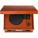 The top view of the Crosley Lancaster Entertainment Center - Paprika reveals the open lid with a turntable, tonearm, and platter for vinyl records